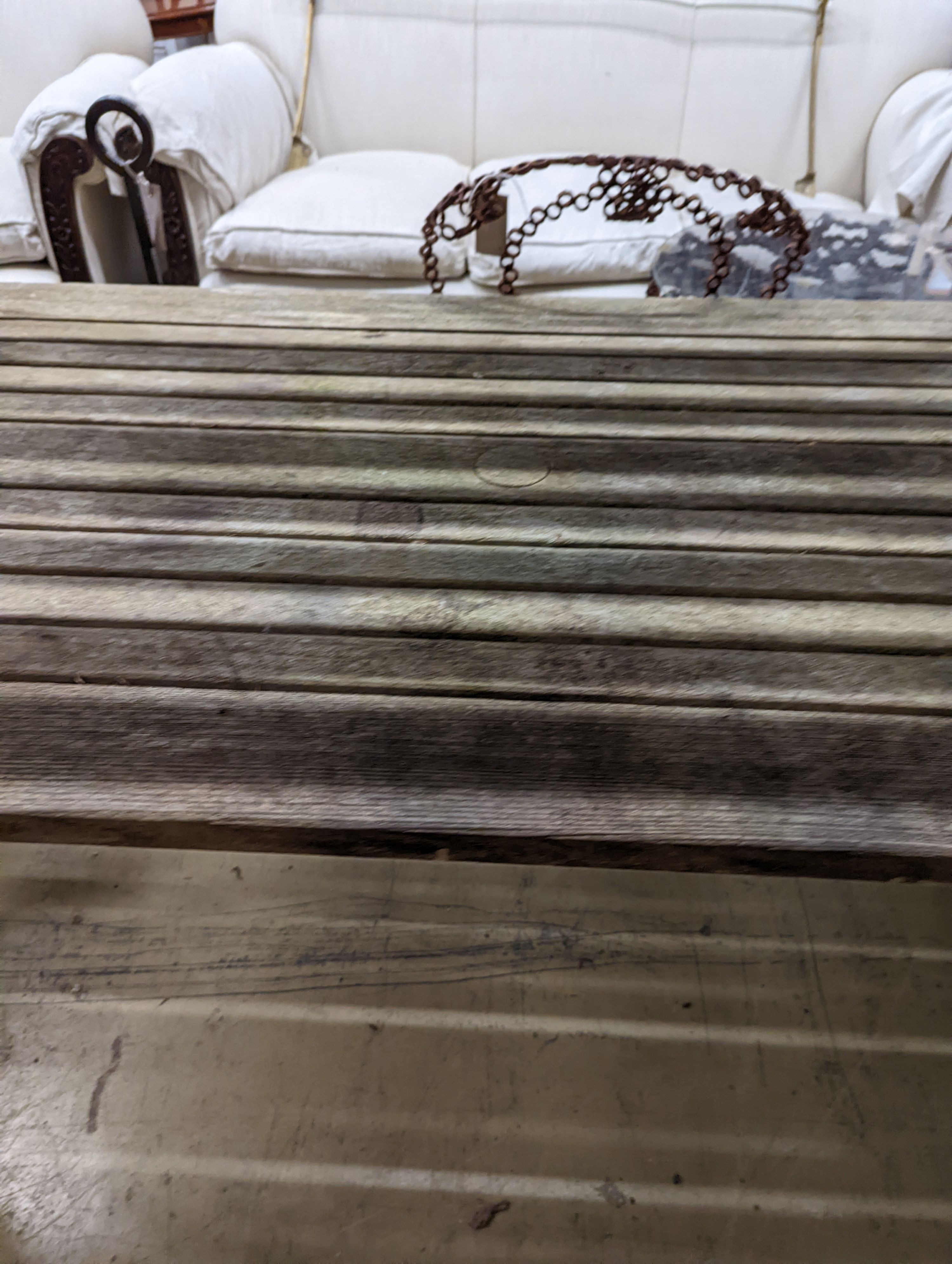 A weathered teak garden bench and rectangular table. Bench - W-122cm, D-54cm, H-83cm. Table - W-149cm, D-70cm, H-74cm.